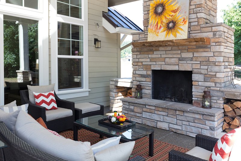 Architectural House Design - Craftsman style home, covered patio with Fireplace photo
